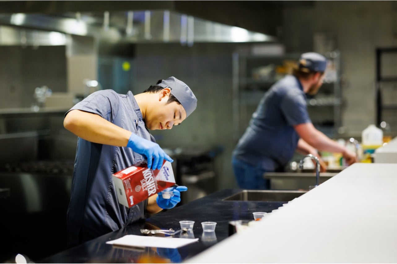 A Cal Poly College of Agriculture, Food and Environmental Sciences student assisting with a culinary project. 