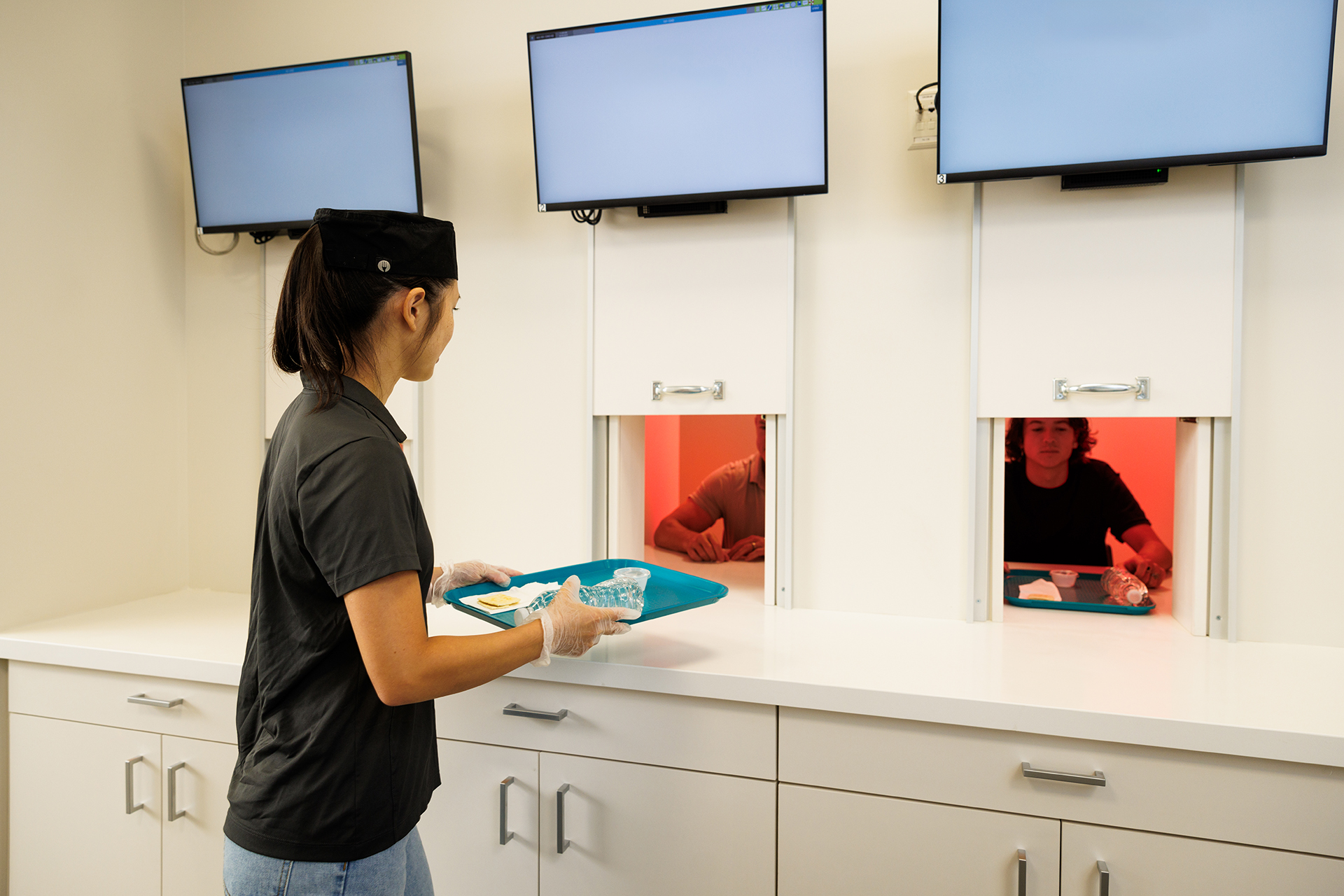 A student works with tester in the culinary sensory lab.