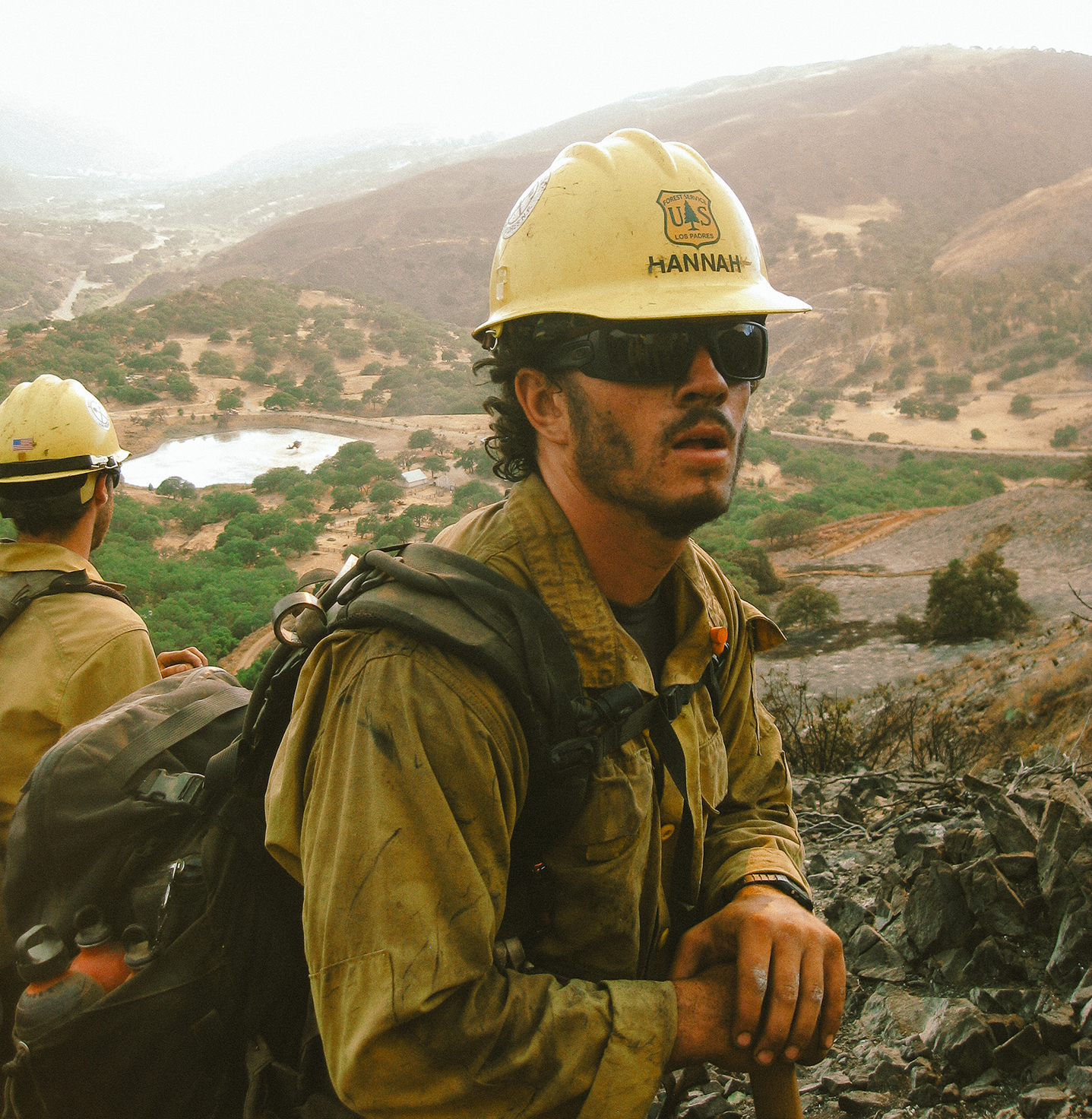 A student firefighter take a break while fighting a wild fire. 
