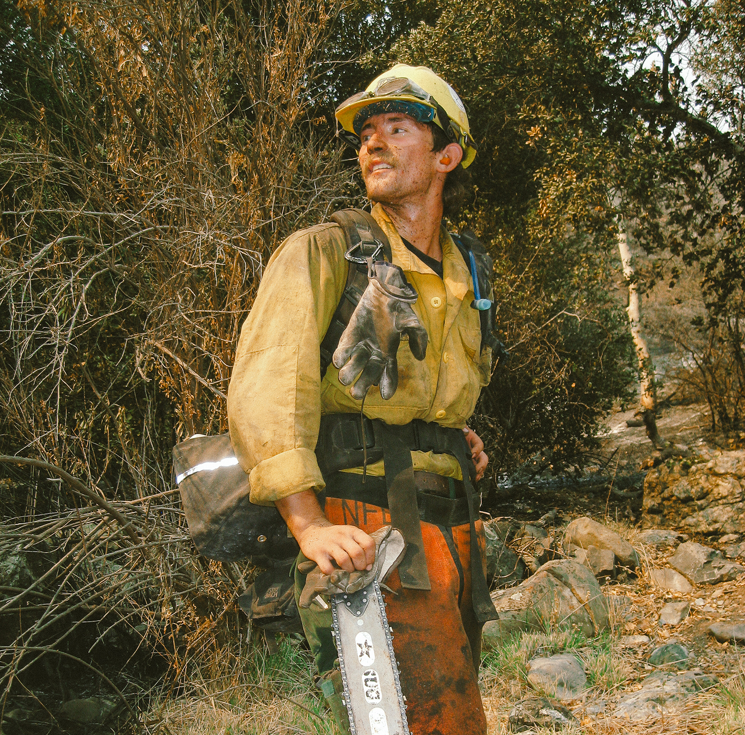 A student takes a break while fighting wildfire. 