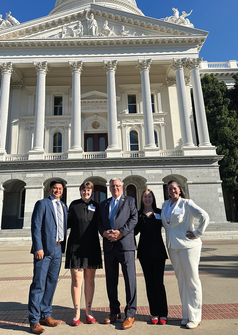 Cal Poly President Jeffrey Armstrong stands with Marc Cabeliza, Brisa Bergfeld, Milena Wilson and Sofia Patnode in front of the California State Capital building. 