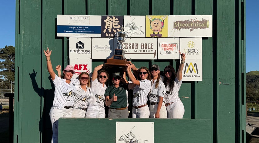 The Cal Poly Women's Polo team hoist a trophy above their heads. 