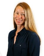 Professional headshot of a smiling woman with long blonde hair wearing a dark blouse against a light studio background.