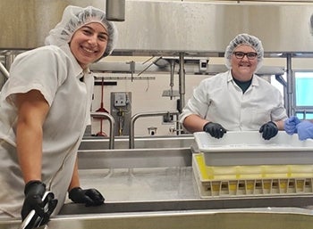 Marissa Johnston (left) and Jenna Bates inside the Cal Poly Dairy. 