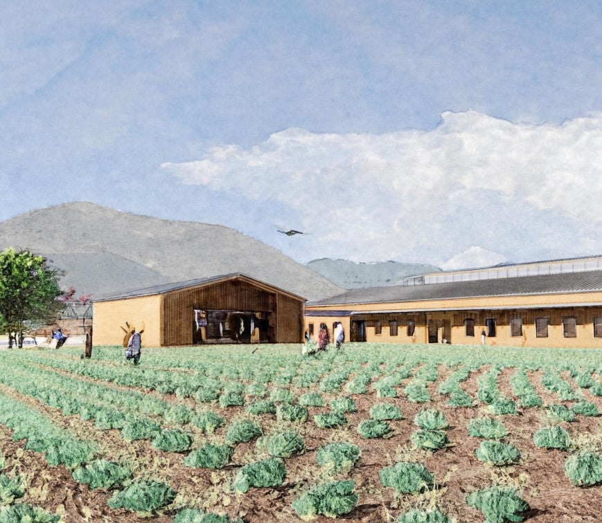 Watercolor-style rendering of a farm and agricultural education facility beside cultivated crop fields with mountains in the background.