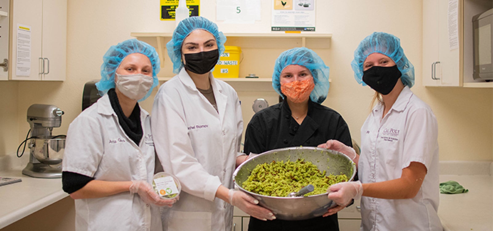 Four Food Science and Nutrition students pose with their project. 