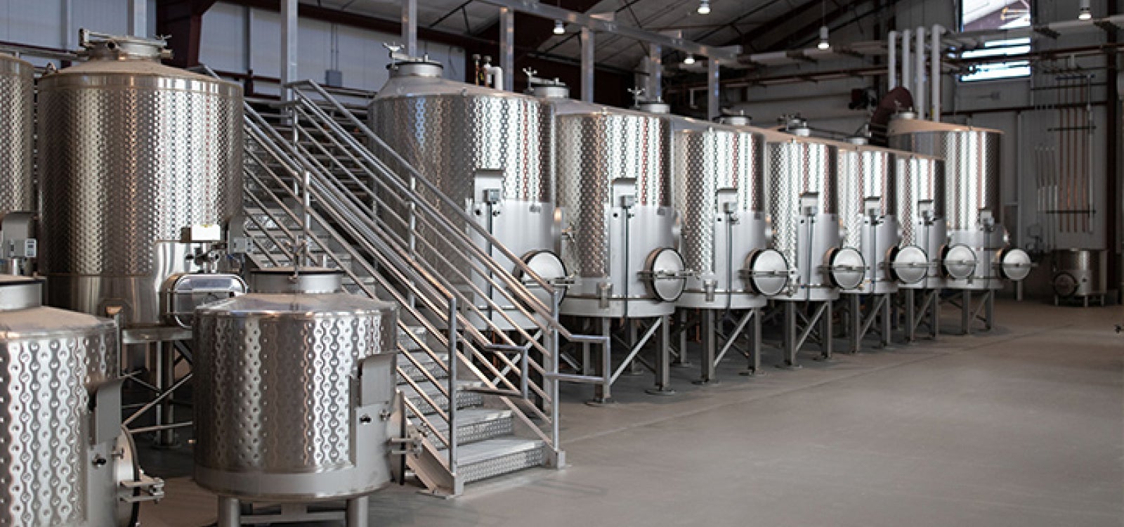 A row of wine distillers in the JUSTIN and J. LOHR Center for Wine and Viticulture