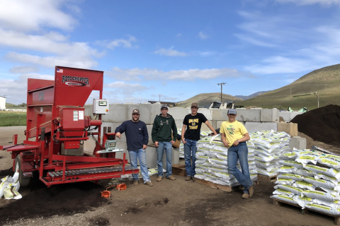 Cal Poly students with pallets of certified organic compost ready for sale.