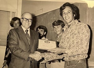 Dean Emeritus Howard Brown with a student in an archive photo. 