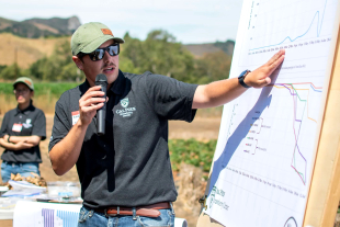 A graduate student presents during Strawberry Field Day. 