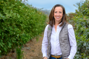 Brie Smith standing in a farm field. 