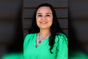 A portrait of Carmen Licon-Cano looking at the camera wearing a green blouse. Licon-Cano is the director of the Dairy Products Technology Center