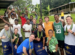 Cal Poly Maritime Academy students pose for a photo with Fijians.
