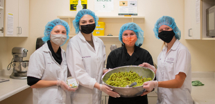 Four Food Science and Nutrition students pose with their project. 