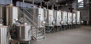 A row of wine distillers in the JUSTIN and J. LOHR Center for Wine and Viticulture