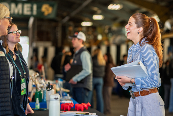 A College of Agriculture, Food and Environmental Sciences student talks with an employer.