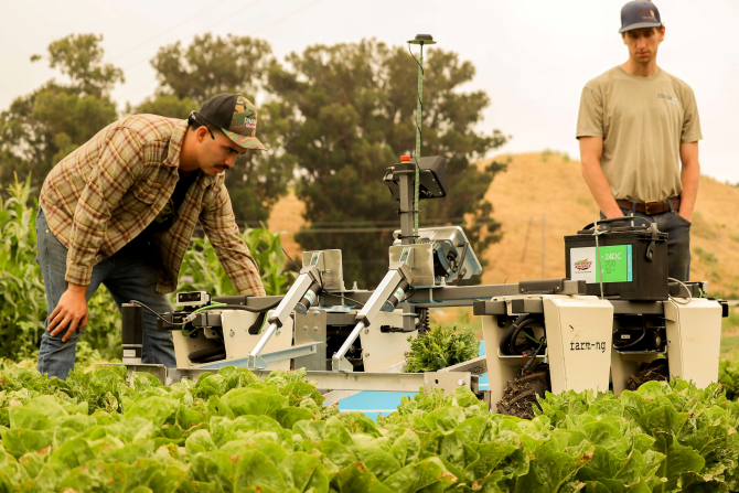 Students testing an automatic lettuce harvester built in class. 