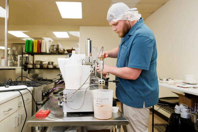 A food science graduate student studying a process for transforming carrot pomace into a puffed snack.