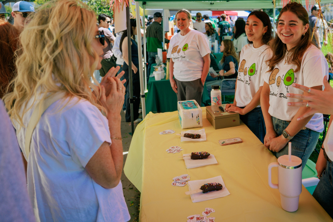 Student from the Nutrition Club talk with visitors during Cal Poly''s Open House. 