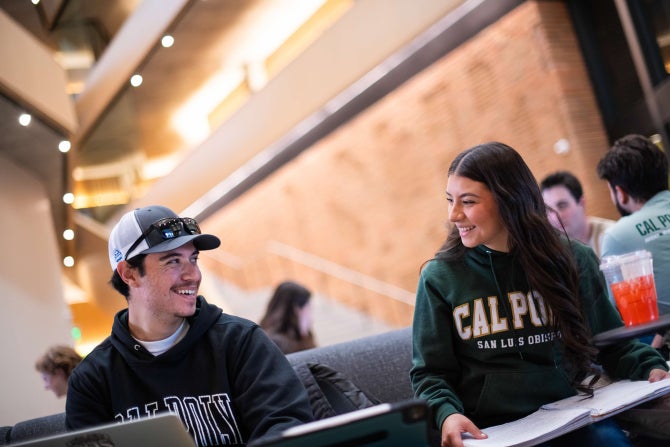 Students smile at each other while studying in Cal Poly's Frost Center