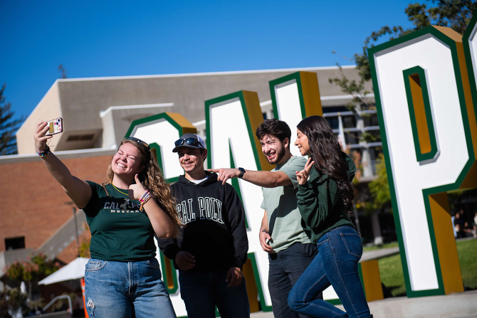 College of Agriculture, Food and Environmental Sciences students take a selfie with the Cal Poly letters