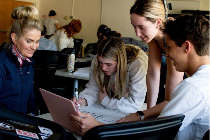 Students work with Professor Christiane Schroeter to create a marketing plan. 