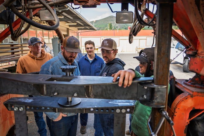 Bioresources and agricultural engineering students work on an agave harvester as part of a senior project. 