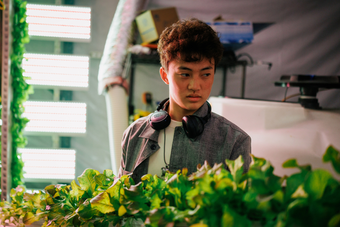 A Cal Poly bioresource and agricultural engineering student works in the Vertical Farm