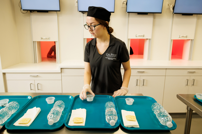 A student prepares a test at the sensory evaluation lab.