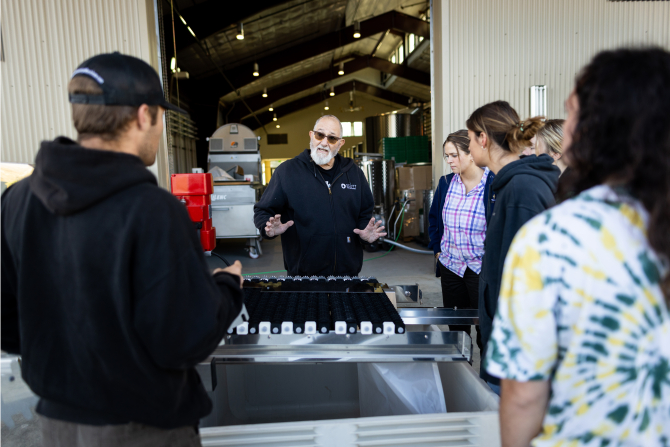 Students receive instructions as they prepare to process grapes from the on-campus vineyard.