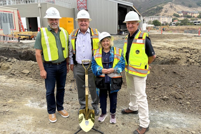 Charles and Claire Jacobson pose for a photo with Dean Brian Horgan in front of the Animal Health Center.