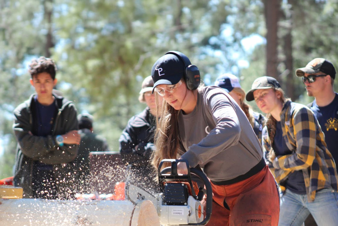 A Cal Poly student competes in a logging event. 