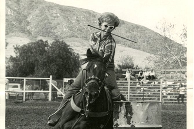 A barrel racer in a historic photo of Poly Royal Rodeo at Cal Poly. 