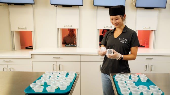 A student prepares a study in the culinary teaching lab and sensory lab.