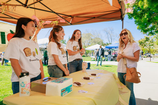 A parent talks with Cal Poly Nutrition Club students during Open House. 