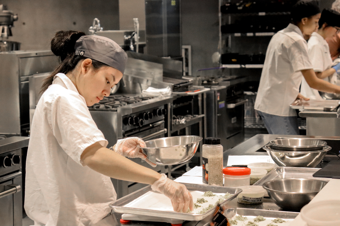 A student prepares food in the Culinary Test Kitchen at Cal Poly. 