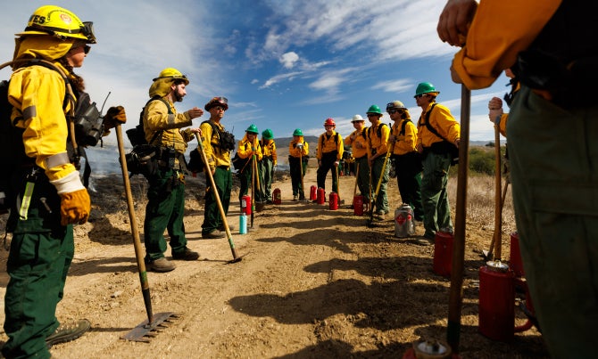 Students in the prescribed fire senior project class use drip torches to intentionally set grass ablaze at Escuela Ranch during a prescribed burn, the first ever on Cal Poly’s campus. 