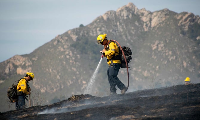 Students participate in a prescribed burn on campus. 