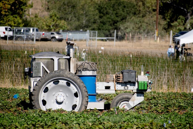 An automous tractor works a field on Cal Poly's campus. 