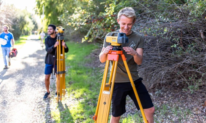 A student uses surveying equipment during a class. 