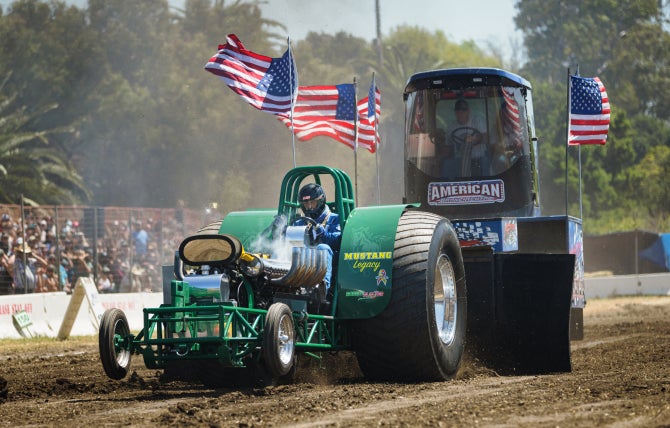 The Cal Poly Tractor Pull Team competes with its tractor, Mustang Legacy, during Open House. 