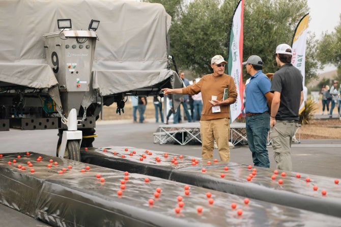 Industry professionals meet during strawberry field day. 