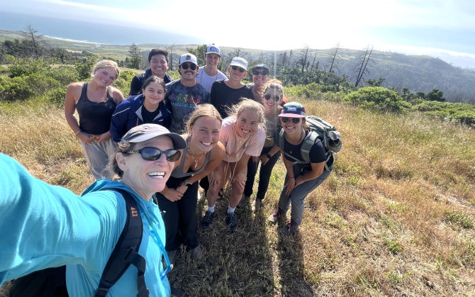 An experience industry management professor takes a selfie with a group of students while on a field trip to Swanton Pacific Ranch. . 